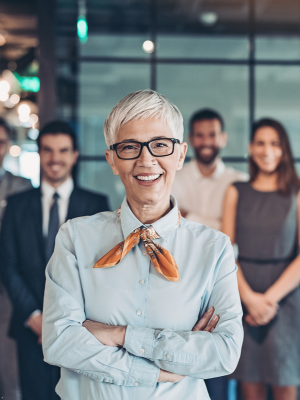 Professional team standing confidently in a modern Dubai office environment