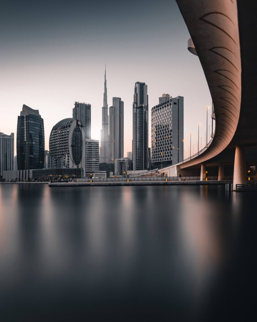 Skyline view of Dubai’s Business Bay and Downtown area with modern high-rise buildings and a bridge over the water