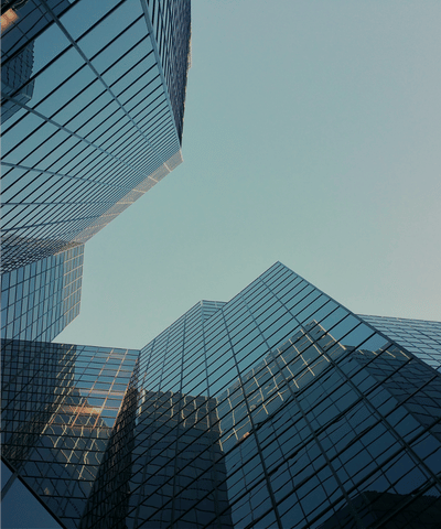 Modern glass office buildings in Dubai under a clear sky